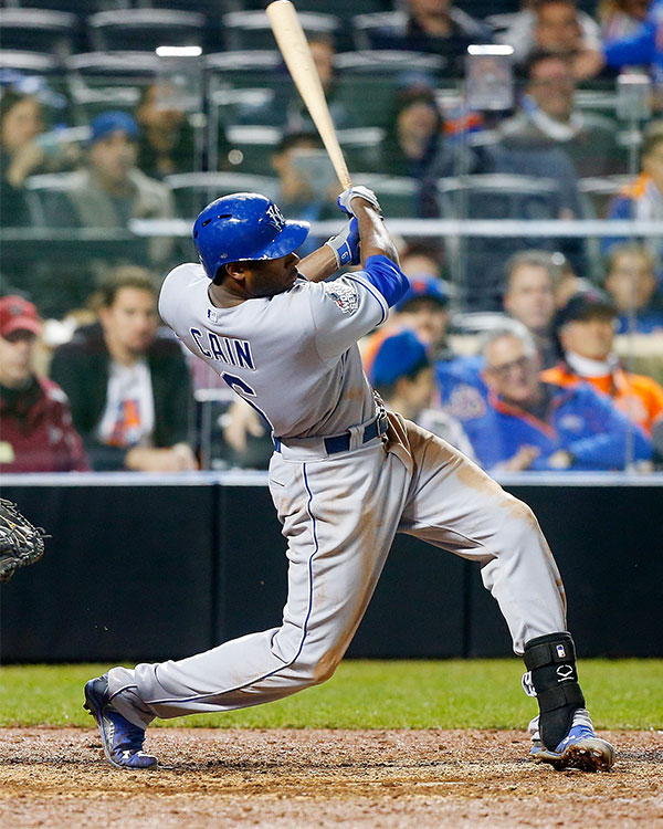 A baseball player swings a bat.