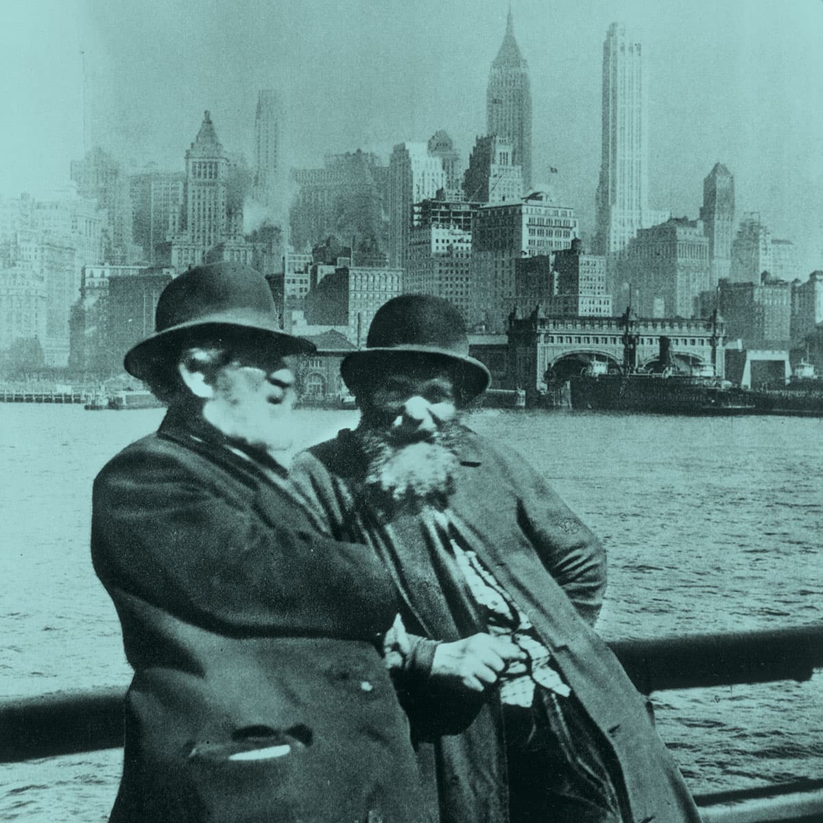 Two immigrants with New York City in the background.
