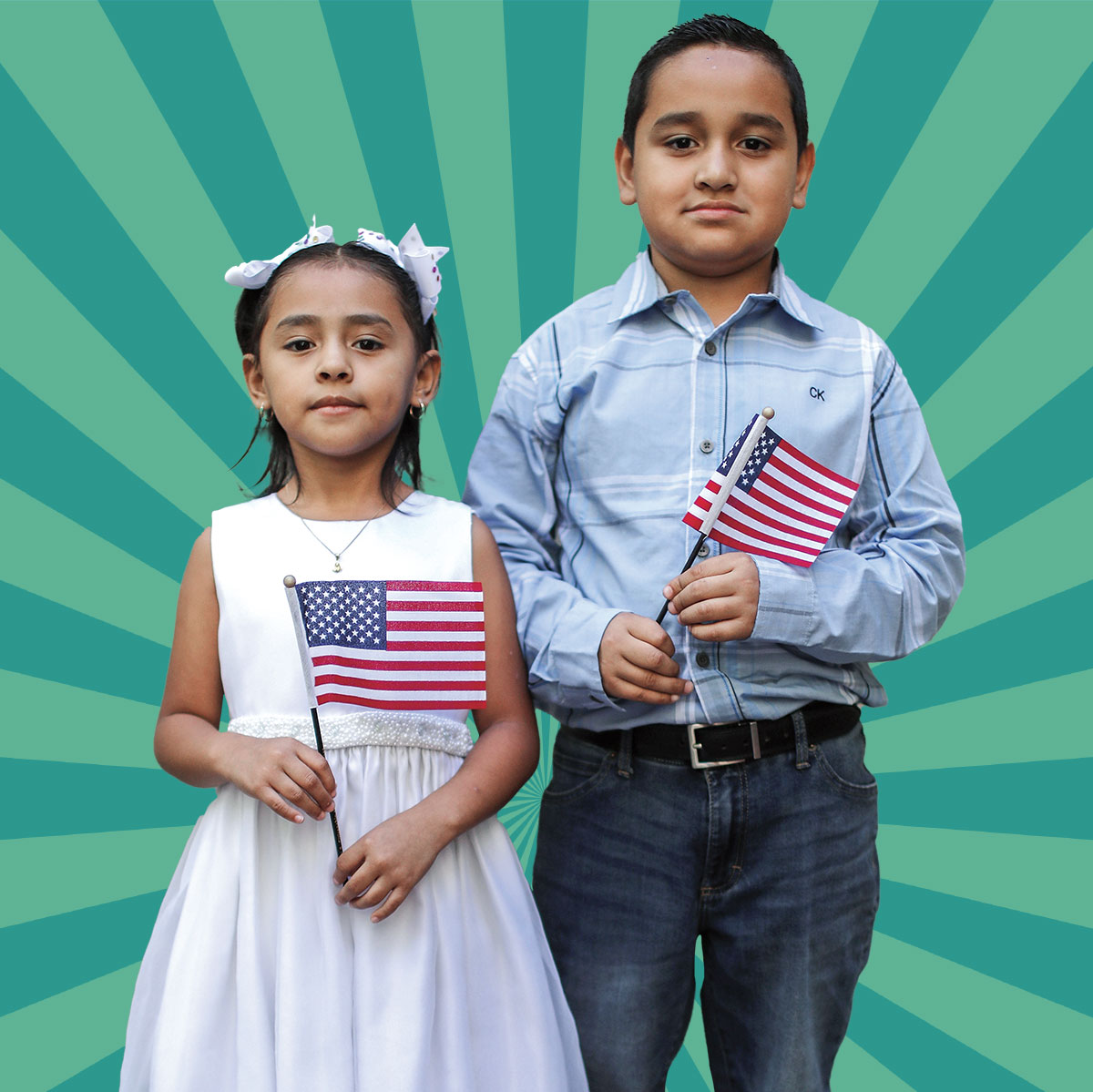 A young boy and girl hold American flags.