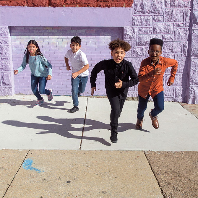 Enlargeable photo of four students running