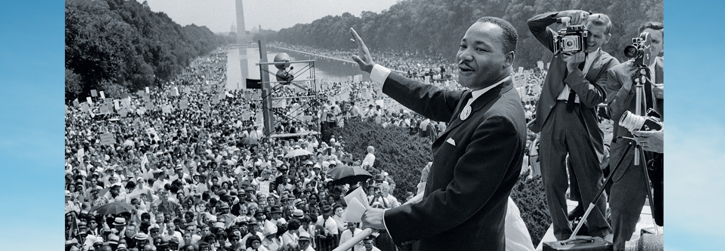 Black & white photo of MLK Jr. delivering a speech in Washington D.C. in front of huge crowd