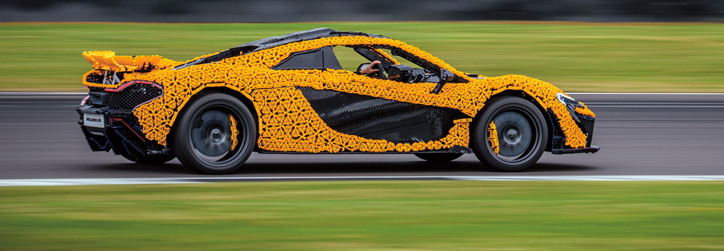 a car made out of black and yellow LEGO pieces