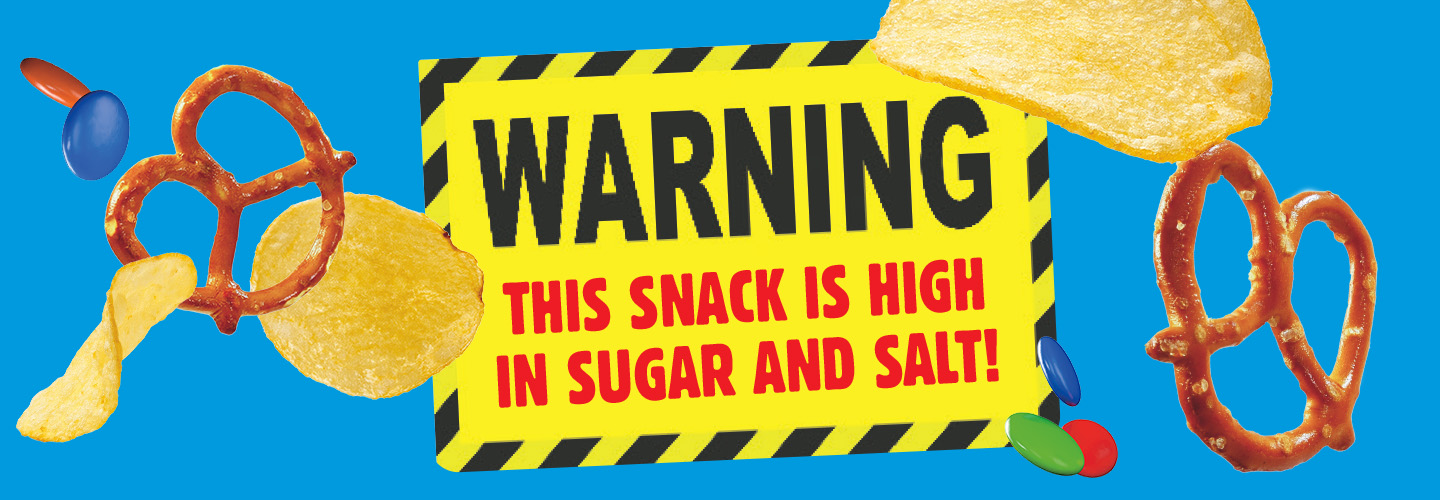 pretzels and potato chips with a sign that reads WARNING THIS SNACK IS HIGH IN SUGAR AND SALT