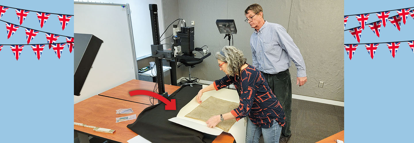 Image of people framing a rare document